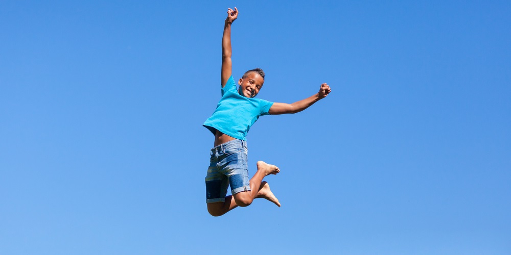 Boy bouncing up into the sky